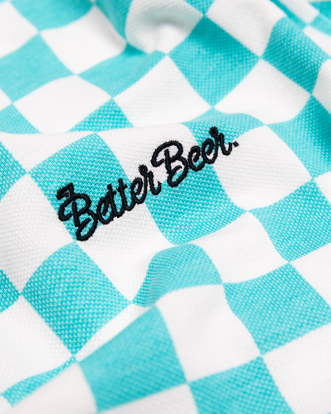 Checkered fabric with 'Better Beer' text on a turquoise and white background