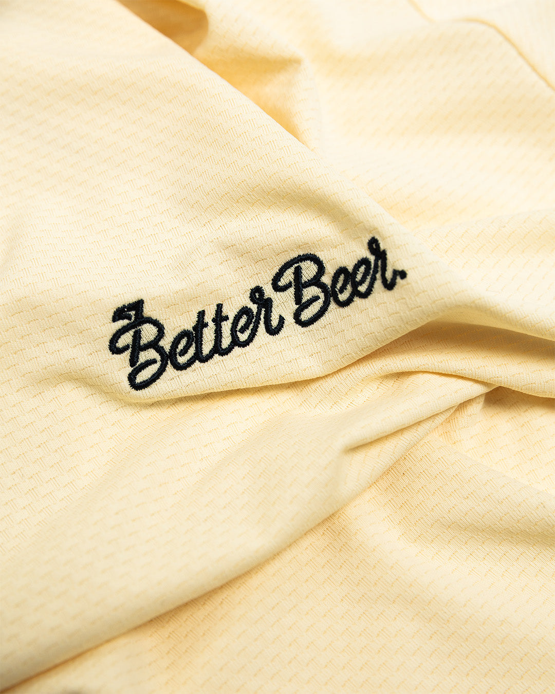 Beige fabric with 'Better Beer' embroidered in black